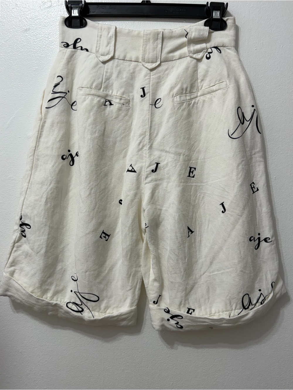 AJE IVORY High-Waist Shorts with Black Script Print